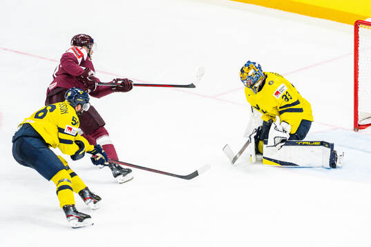 Rudolfs Balcers of Latvia against goaltender Samuel Ersson