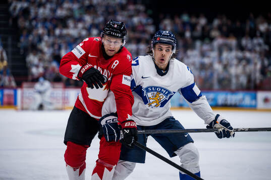 Nathan MacKinnon of Canada and Atro Leppänen of Finland