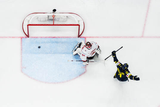 Mikael Backlund of Sweden celebrates the 1-1 goal  in front of goaltender Jordan Binnington of Canada