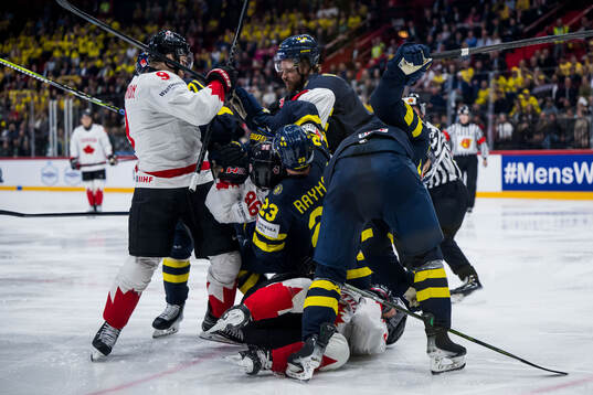 Lucas Raymond and Jonas Brodin of Sweden in a fight with Sidney Crosby and Nathan MacKinnon of Canada