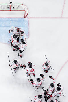Goaltender Jordan Binnington of Canada celebrate with teammates