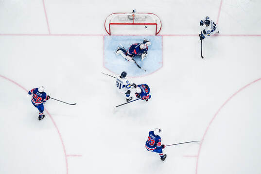 Patrik Puistola of Finland (not pictured) scored 1-2 behind Andrew Peeke, Conor Garland, goaltender Jeremy Swayman and Alex Vlasic of USA