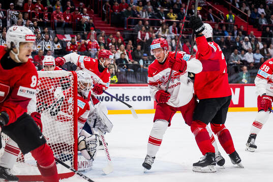 Goaltender Frederik Dichow and Matias Lassen of Denmark