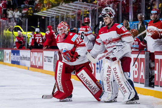 Goaltender Sebastian Dahm and goaltender Frederik Dichow of Denmark