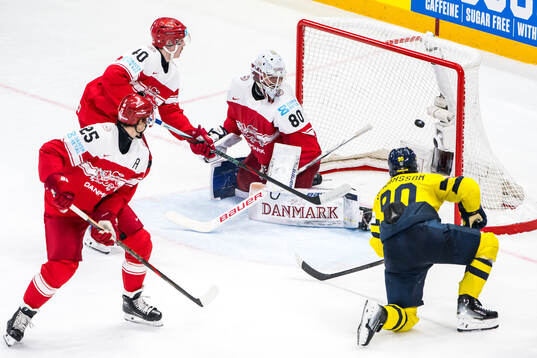 Marcus Johansson of Sweden scores 3-0 past Anders Koch, Oliver Lauridsen and goaltender Frederik Dichow of Denmark