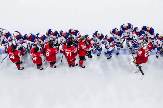 Players of Switzerland greet players of USA