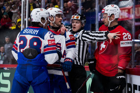 Timo Meier of Switzerland against Zeev Buium and Shane Pinto of USA
