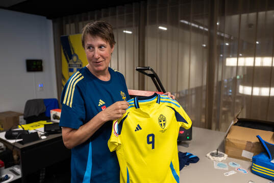 Equipment manager Jessica Karlsson holds the match shirt of
