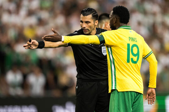 Referee Vassilis Fotias and Shaquille Pinas of Hammarby