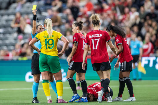 Referee  Michaela Pachtova gives a yellow card to Cathinka