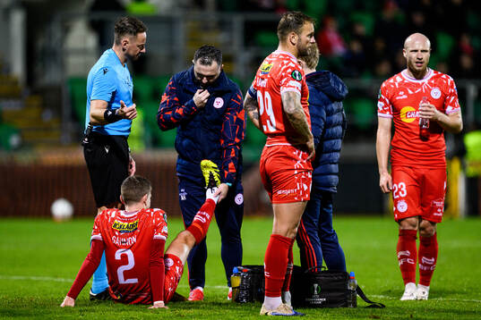 Sean Gannon of Shelbourne FC receives medical attention