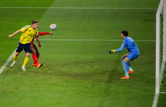 Viktor Gyökeres of Sweden and goalkeeper Gregor Kobel of