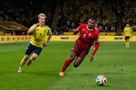 Lucas Bergvall of Sweden and Manuel Akanji of Switzerland