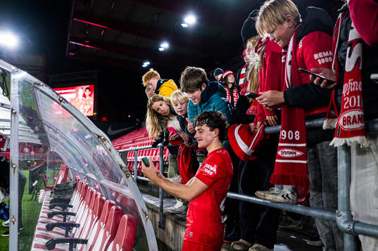 Denzel De Roeve of Brann taking a selfie with fans
