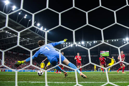 Benjamin Nygren of Sweden scores the 1-1 goal behind