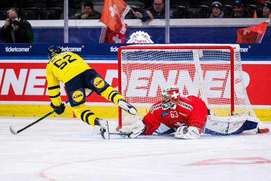 Felix Nilsson of Sweden scores the game winning goal behind