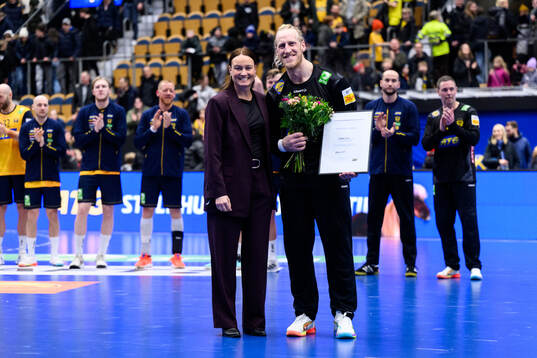 Goalkeeper Mikael Apelgren of Sweden is awarded player of