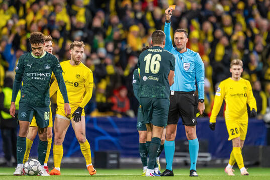Rodri of Manchester City receives a red card from referee