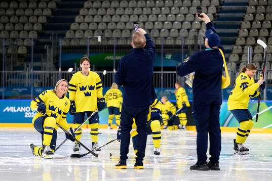 Hanna Olsson and Lisa Johansson of Sweden take photos at a