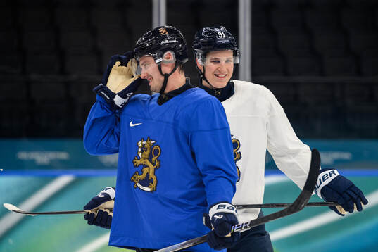 Sebastian Aho and Oliver Kapanen of Finland at an ice