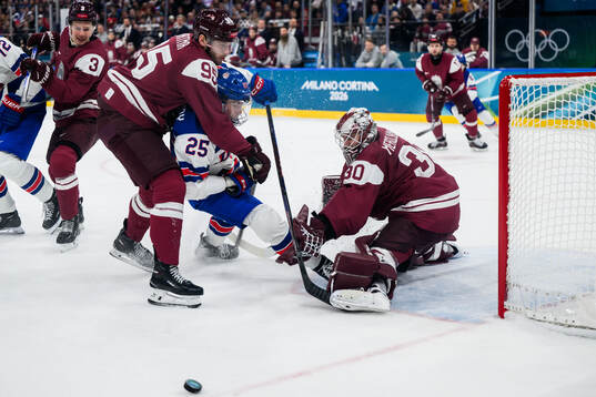 Charlie McAvoy of USA against Oskars Batna and goaltender