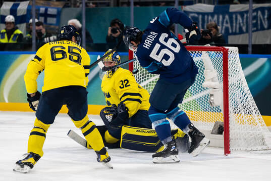 Goaltender Filip Gustavsson of Sweden and Erik Haula of