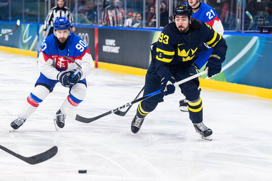 Tomas Tatar of Slovakia and Mika Zibanejad of Sweden in the