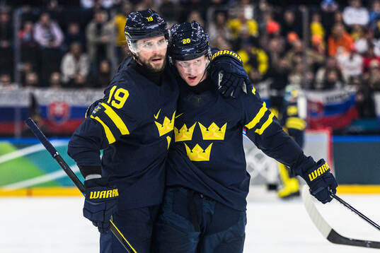 Adrian Kempe and Rasmus Dahlin of Sweden celebrate 2-1 in