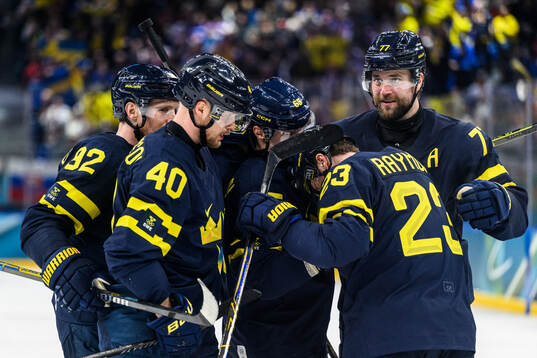 Elias Pettersson of Sweden celebrates 4-2 with teammates in