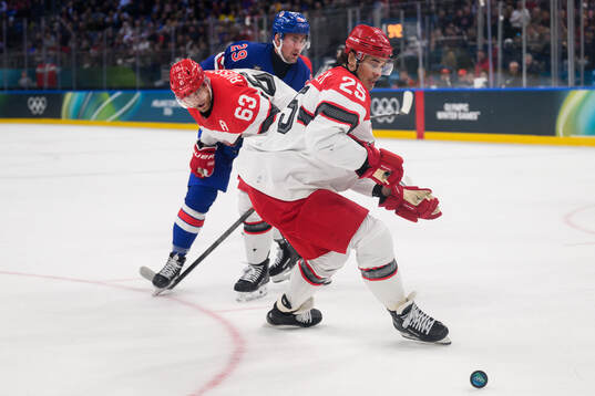 Brock Nelson of USA against Patrick Russell and Oliver