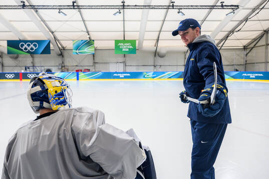 Goalkeeper coach Anthon Hansson speaks to goaltender Jesper