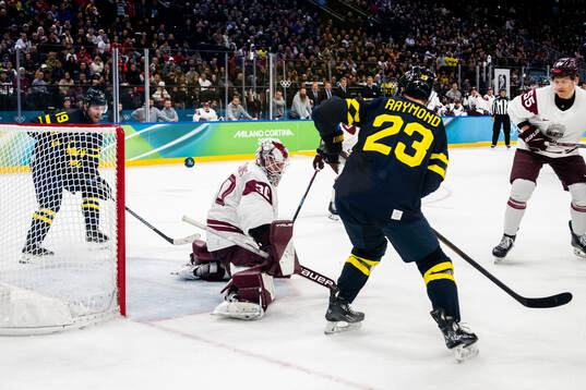 Adrian Kempe of Sweden and goaltender Elvis Merzlikins of