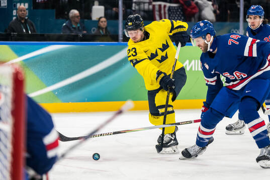 Lucas Raymond of Sweden and Jaccob Slavin of USA in the
