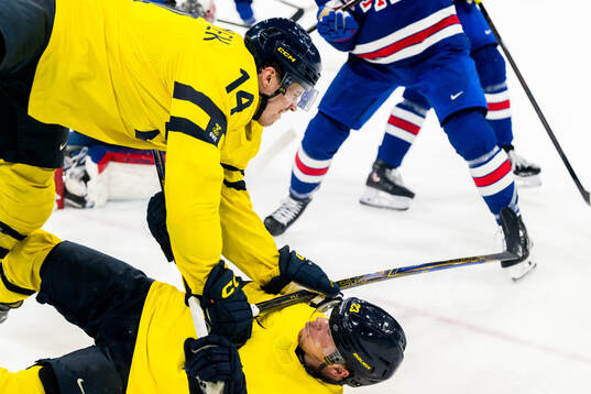 Joel Eriksson Ek and Lucas Raymond of Sweden collide in the