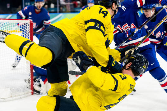 Joel Eriksson Ek and Lucas Raymond of Sweden collide in the