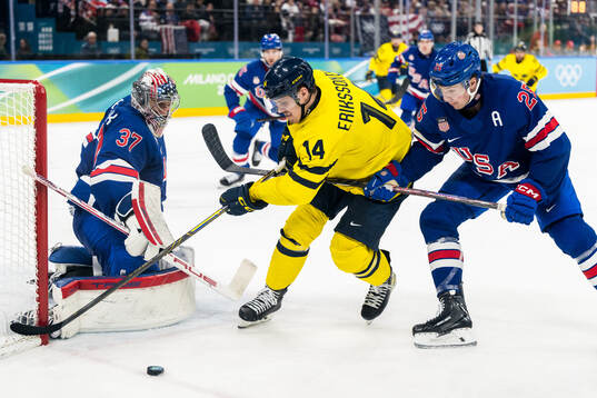 Goaltender Connor Hellebuyck and Charlie McAvoy of USA as