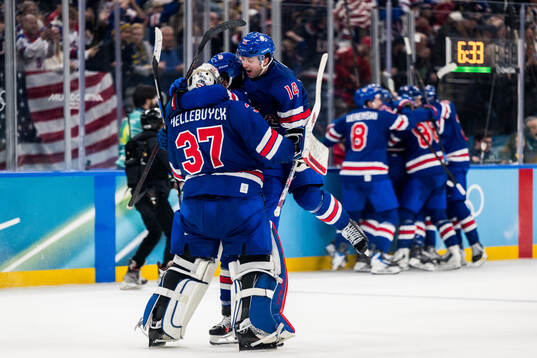 Goaltender Connor Hellebuyck and Brock Faber of USA
