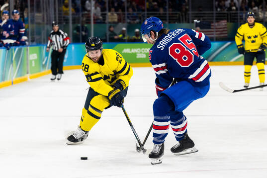 Elias Lindholm of Sweden and Zach Werenski of USA in the