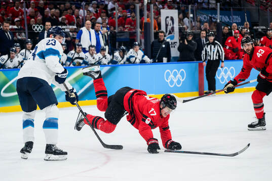 Esa Lindell of Finland and Macklin Celebrini of Canada in
