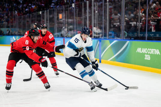 Travis Sanheim of Canada and Anton Lundell of Finland in