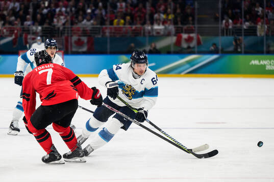 Devon Toews of Canada and Mikael Granlund of Finland in the