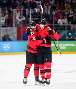 Shea Theodore and Travis Sanheim of Canada celebrate the