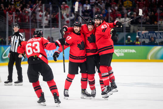 Shea Theodore, Travis Sanheim and Tom Wilson of Canada
