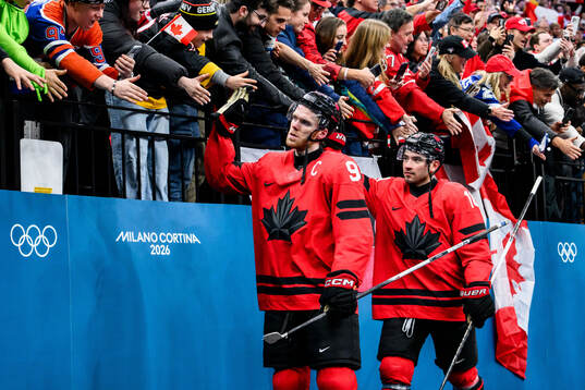 Sam Bennett and Nick Suzuki of Canada celebrate with fans