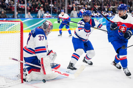 Goaltender Connor Hellebuyck and Brock Faber of USA with