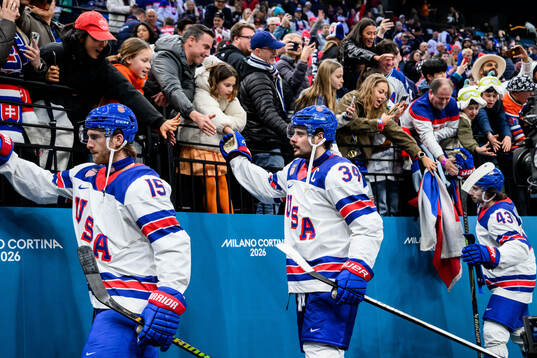 Noah Hanifin and Auston Matthews of USA celebrate with fans