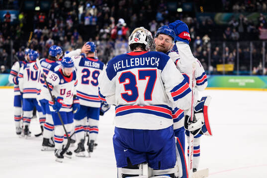 goaltender Connor Hellebuyck and Jack Eichel of USA