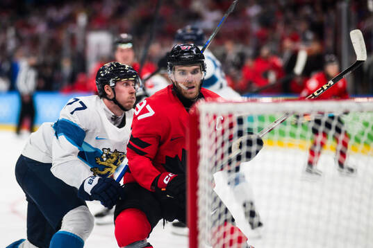 Niko Mikkola of Finland and Connor McDavid of Canada in the