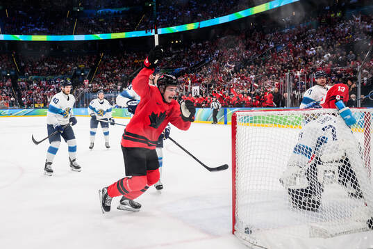 Macklin Celebrini and Sam Reinhart of Canada celebrate the