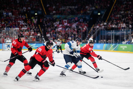 Kaapo Kakko of Finland against Mitch Marner, Colton Parayko